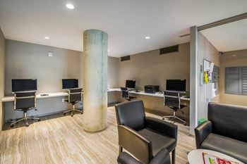 A conference room with a long table and chairs.